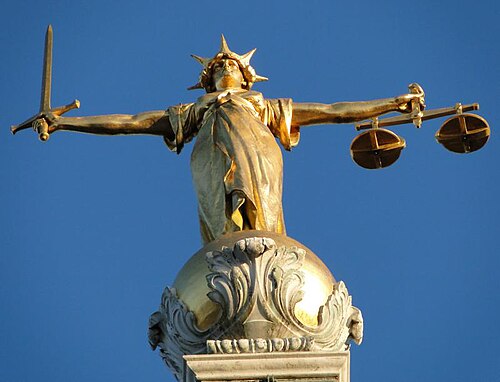 A statue of Lady Justice holding scales, at the Old Bailey, London